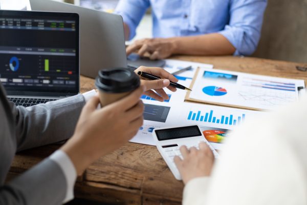 Financial consulting business meeting together to discuss financial chart analysis.